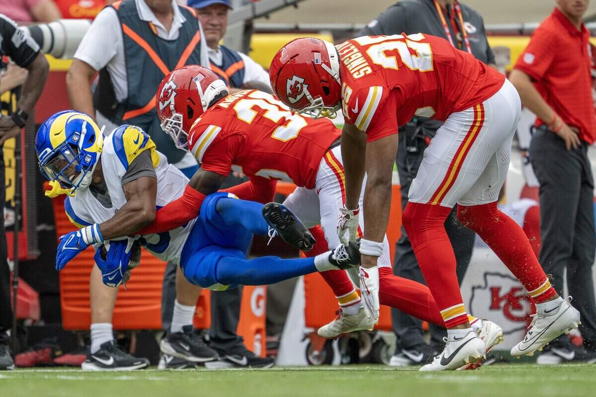 Los Angeles Rams linebacker Monty Rice (8) is tackled by Kansas City Chiefs cornerback Kevin Knowles (35) and safety DeShon Singleton (25) during an NFL preseason game at Arrowhead Stadium on Saturday, Aug. 15, 2026, in Kansas City.