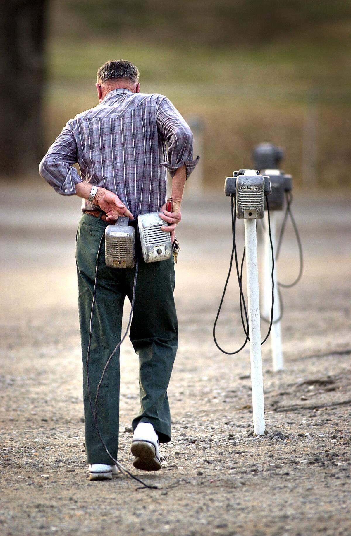 Wes Neal made sure all the speakers were working nearly every day the drive-in was open. In this shot from 2003 his thick leather belt held broken speakers that he repaired in his shop behind the snack bar.