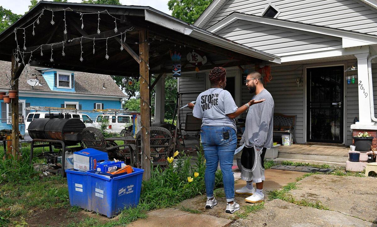 Rosilyn Temple, left, the Founder and Program Director for KC Mothers in Charge, went door to door Thursday afternoon distributing information and talking with residents about the shooting death of Kaitlyn Mahurin, who was killed June 20th at her home in the 2600 block of Cypress Ave. Mahurin was just 20 years old. Temple called on anyone with information about the shooting to come forward. The door hangers she was carrying had a QR code printed on them so any source could remain anonymous.