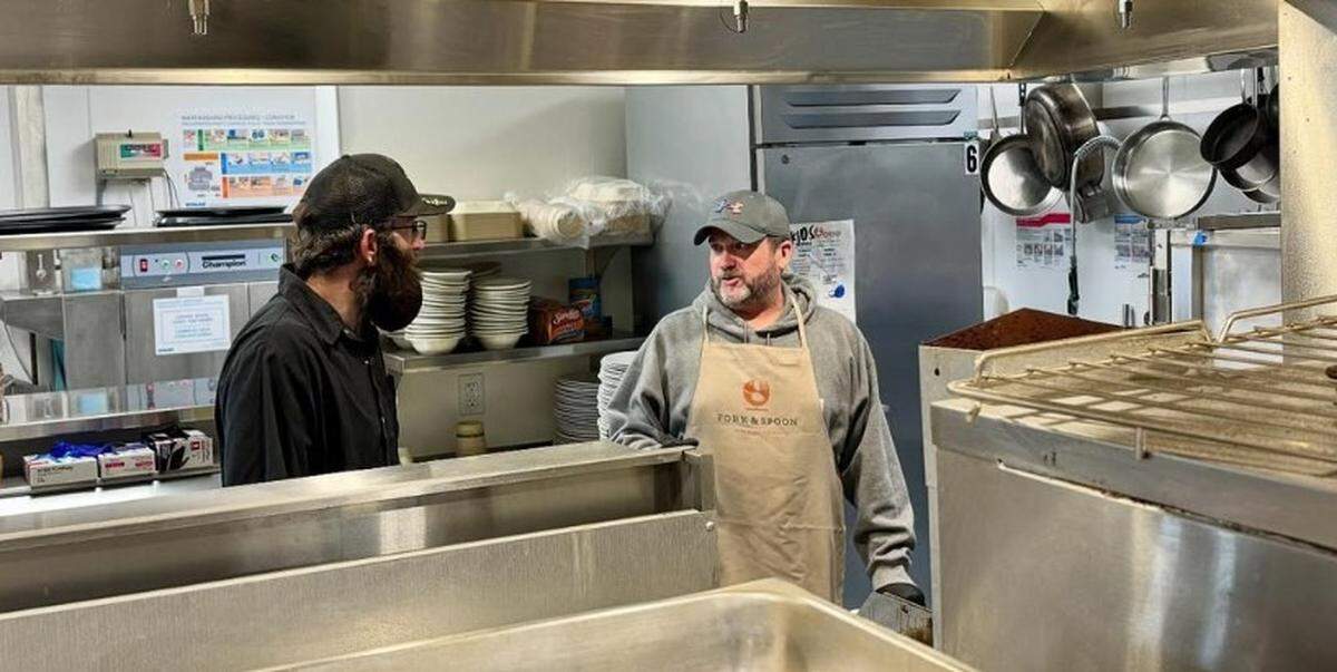 Doug Rush, left, volunteering at Fork & Spoon, a pay-what-you-can restaurant in Bozeman, Montana.