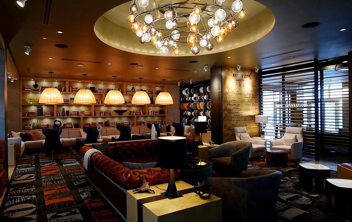 Two Light's amenity level features a club room with a 130-inch TV, a tufted leather couch and winged leather chairs facing a bookcase with banquette seating. The space was designed by Rebecca Jones, a Baltimore-based interior designer.