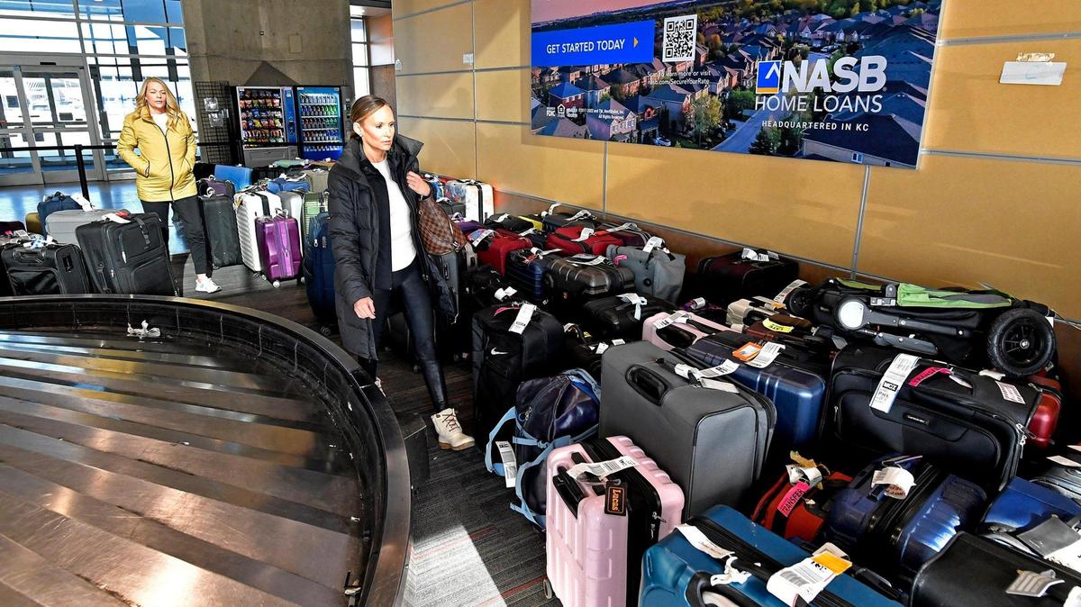 At the Southwest Airlines baggage claim at KCI, Austen Fugate, right, wades through a sea of luggage in search of her bags that were flown to Kansas City without her two days ago. Fugate said that her luggage was flown from Nahsville to Kansas City without her after her flight was canceled. She rebooked and made it to Kansas City Tuesday on an American Airlines flight. She and friend, Bridgett Schmitz eventually found her luggage.