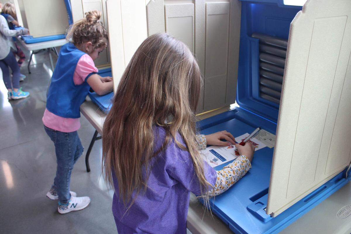 Audree Weyer and Isabel Green, both of Overland Park, vote in the mock election at the Girl Scout Voter Girl Project program in Olathe Jan. 28.