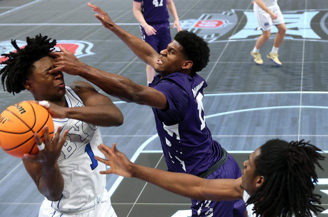 Taj Manning #15 of the Kansas State Wildcats fouls Robert Wright III #1 of the BYU Cougars during the first round game of the Men's 2026 Big 12 Tournament at T-Mobile Center on March 10, 2026 in Kansas City, Missouri.