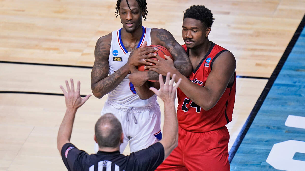 Eastern Washington guard Kim Aiken Jr. (24) and Kansas guard Marcus Garrett, left, battle for the ball during the first half of a first-round game in the NCAA college basketball tournament at Farmers Coliseum in Indianapolis, Saturday, March 20, 2021. (AP Photo/AJ Mast)