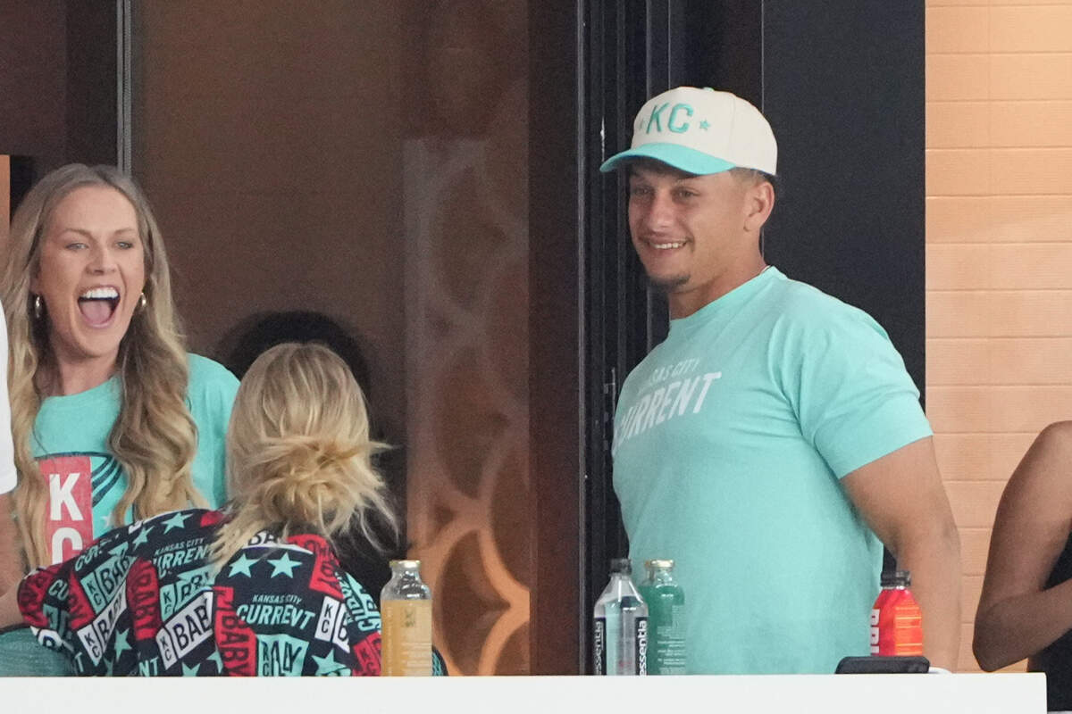 Kansas City Current part-owner Brittany Mahomes, left, and Chiefs quarterback/husband Patrick Mahomes enjoy a laugh during Friday evening’s NWSL match at CPKC Stadium.