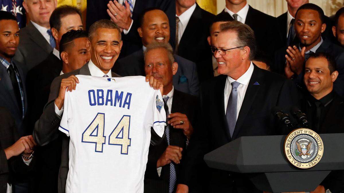 Kansas City Royals manager Ned Yost presents President Barack Obama an honorary jersey at a ceremony honoring the World Series champion Royals in the East Room at the White House on July 21, 2016.