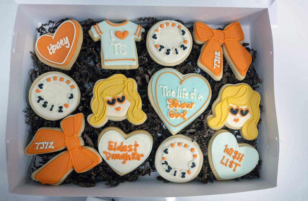 Dolce Bakery in Prairie Village boxed an order of a dozen handmade, Taylor Swift-themed sugar cookies, which the bakery designed in-house, for an order on Thursday, October 2, 2025. Kansas City-area bakeries are seeing a significant demand for pop-icon-themed baked goods, with local fans celebrating the latest moves of Taylor Swift and Chappell Roan.