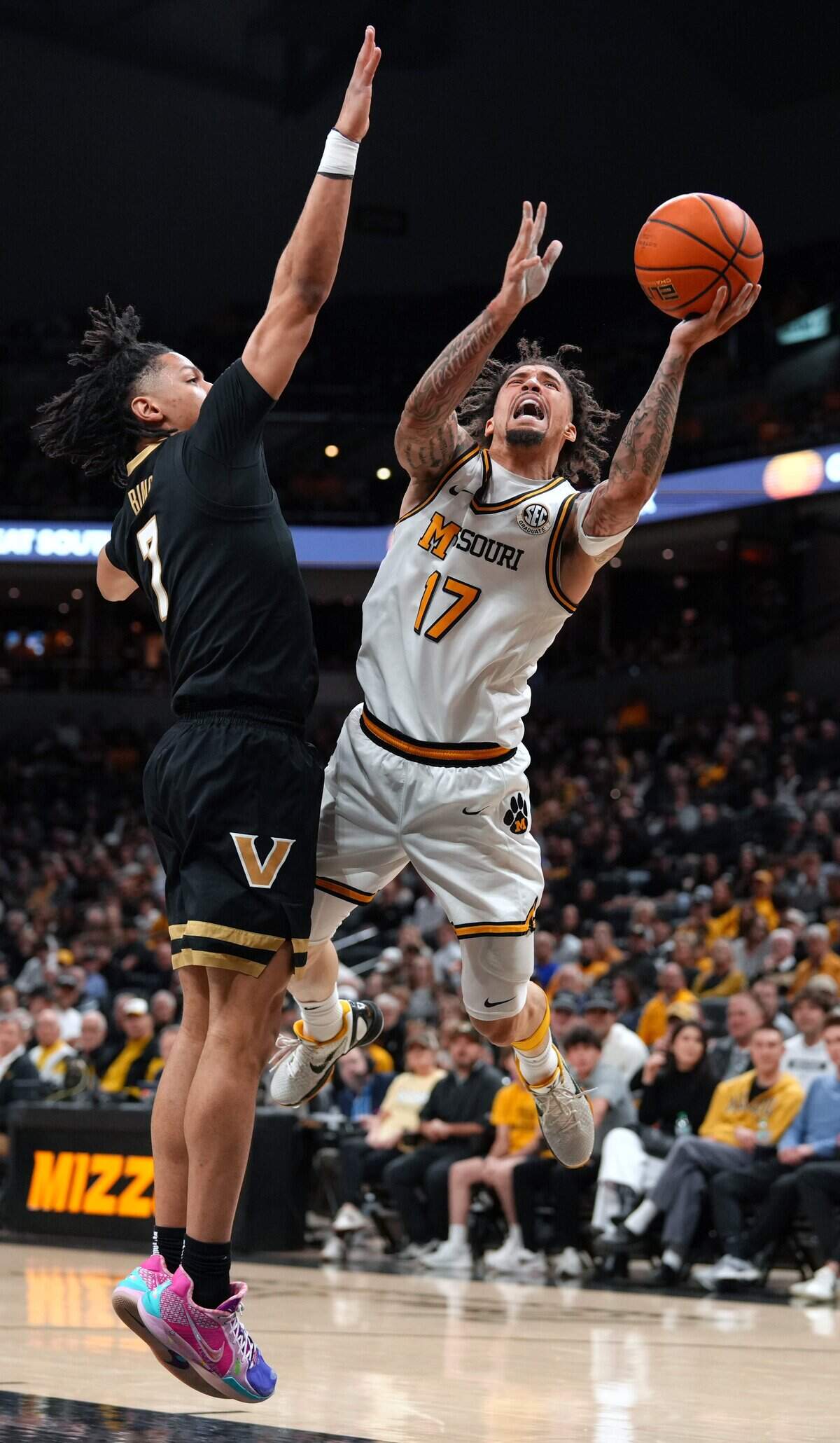Missouri Tigers guard Jayden Stone, right, puts up a shot during an SEC men’s basketball game against the Vanderbilt Commodores at Mizzou Arena in Columbia on Wednesday, Feb. 18, 2026.