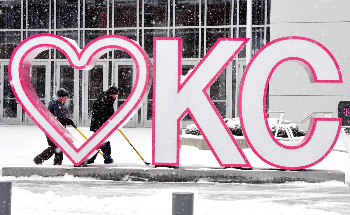 Snow continued to fall Wednesday over downtown Kansas City and the area as a major winter storm made its way across the plains states. Temperatures in the teens made the things even more frigid for Rod Wagner, left, and Ryan Breeden, who cleared away the fresh white blanket from the sidewalks around the T- Mobile Center.