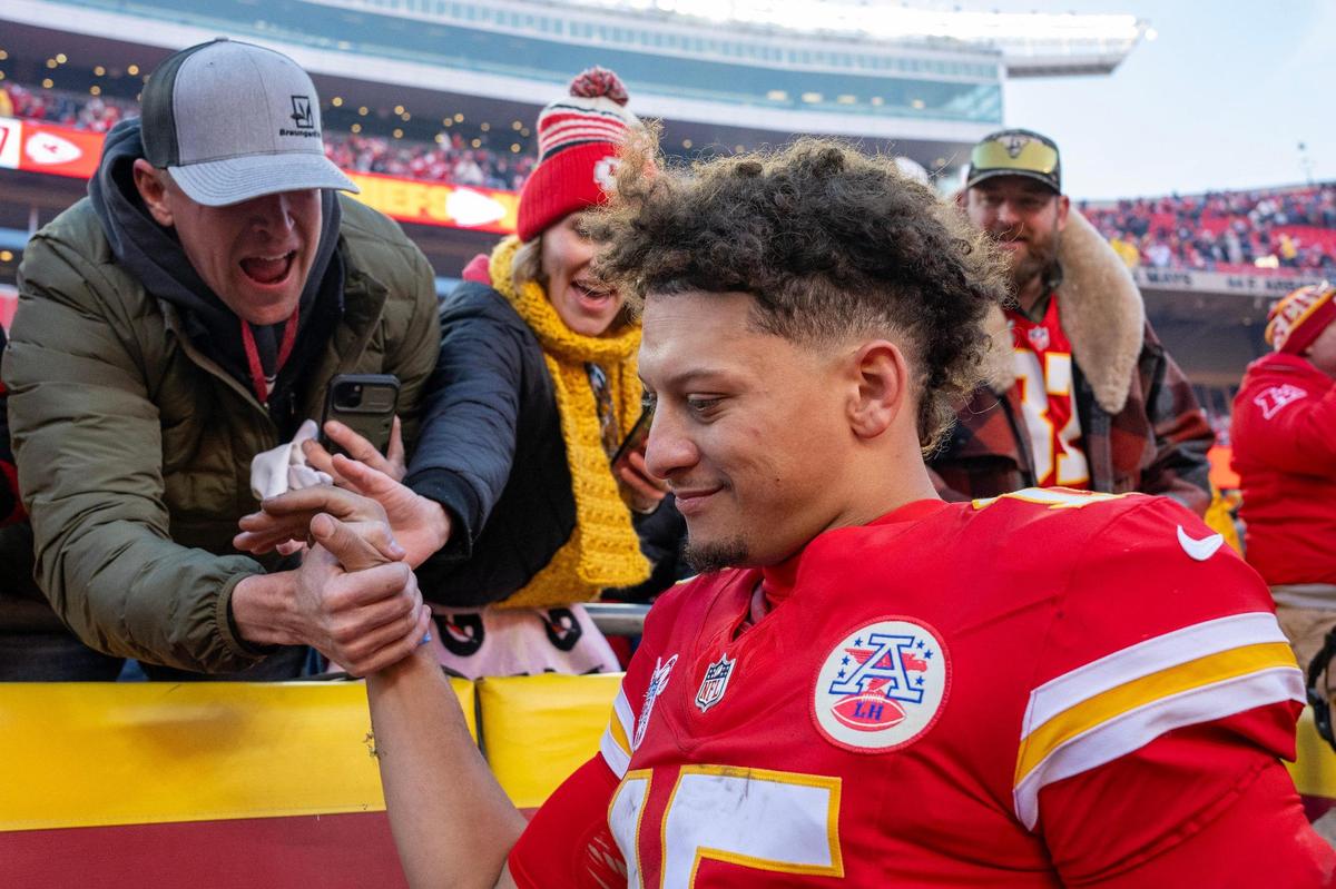 Kansas City Chiefs quarterback Patrick Mahomes (15) smiles while greeting fans and giving them high fives following the Chiefs’ 27-19 victory over the Houston Texans on Saturday, Dec. 21, 2024, at GEHA Field at Arrowhead Stadium.