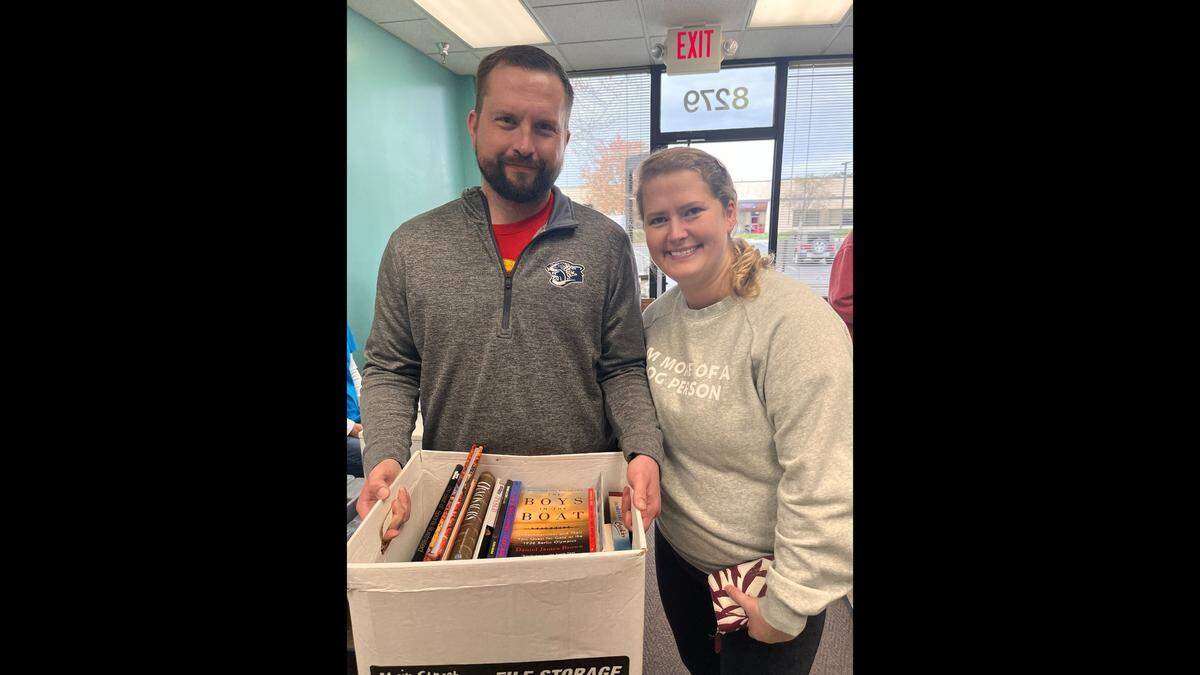 Emily and Cody Bratton found a lot of books for themselves and as holiday gifts for others at the book sale of the Friends of Johnson County Library.