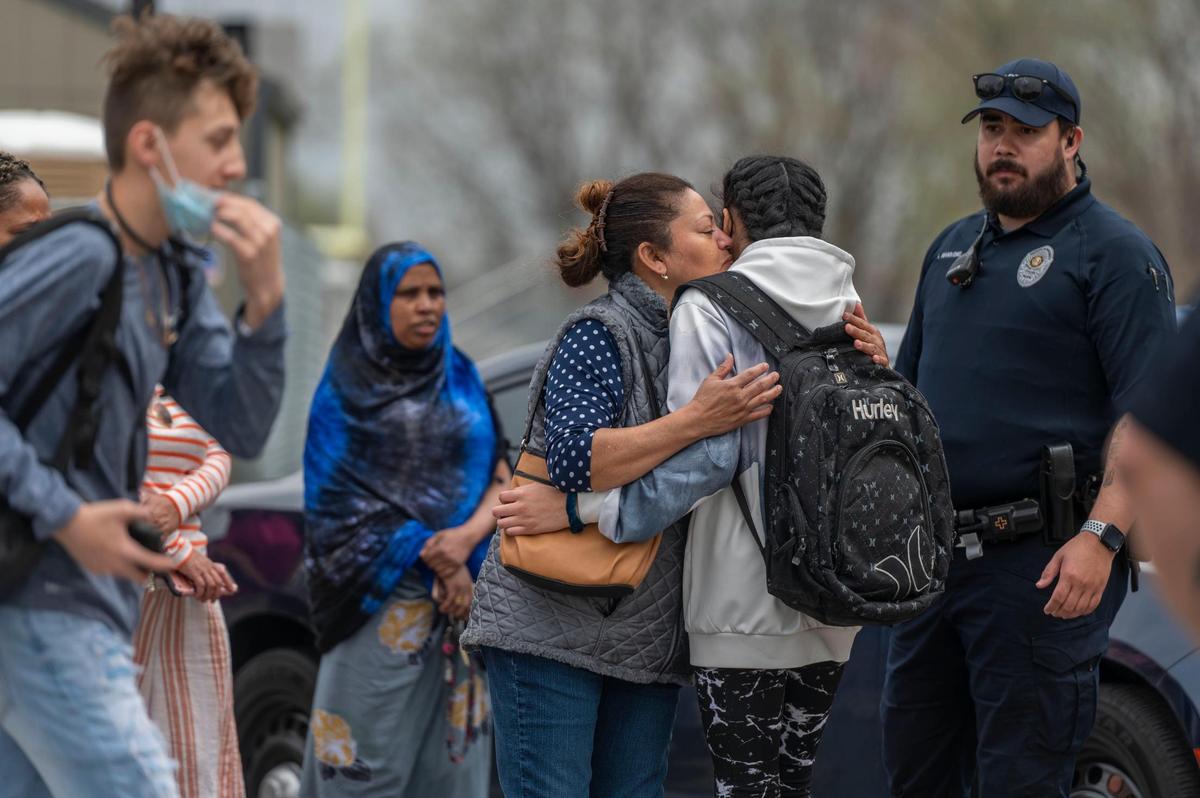Parents wait outside Northeast Middle School to greet their children after one person was injured in a stabbing on Tuesday morning in Kansas City. The victim was taken to the hospital with life-threatening injuries, said Officer Donna Drake, a spokesperson for the Kansas City Police Department. One person has been detained.