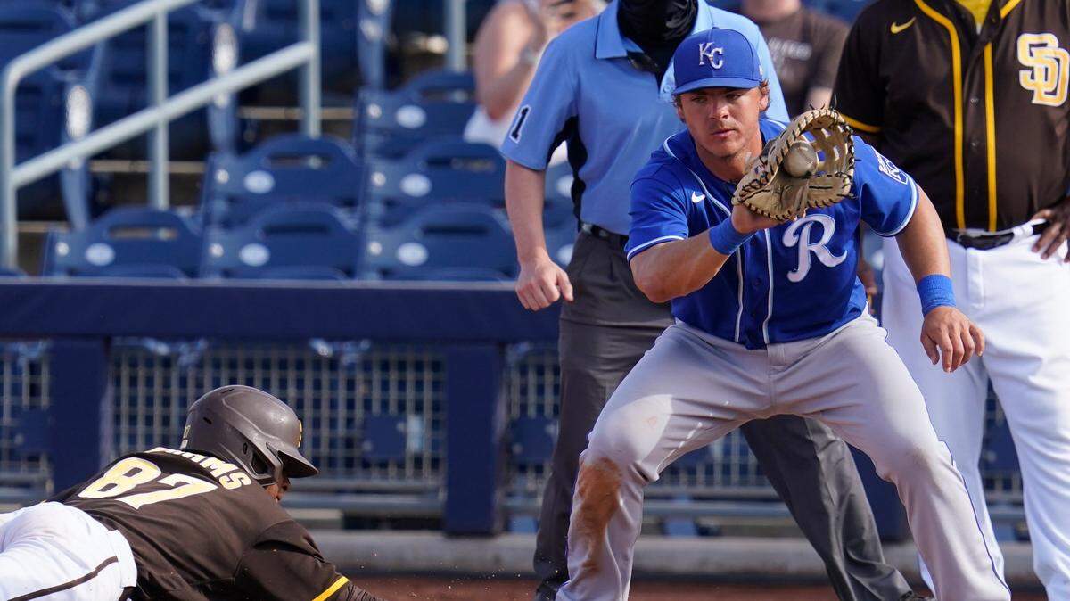 Kansas City Royals first baseman Nick Pratto right takes the throw on a pickoff attempt in the eighth inning of a spring training baseball game Sunday, March 7, 2021, in Peoria, Ariz.
