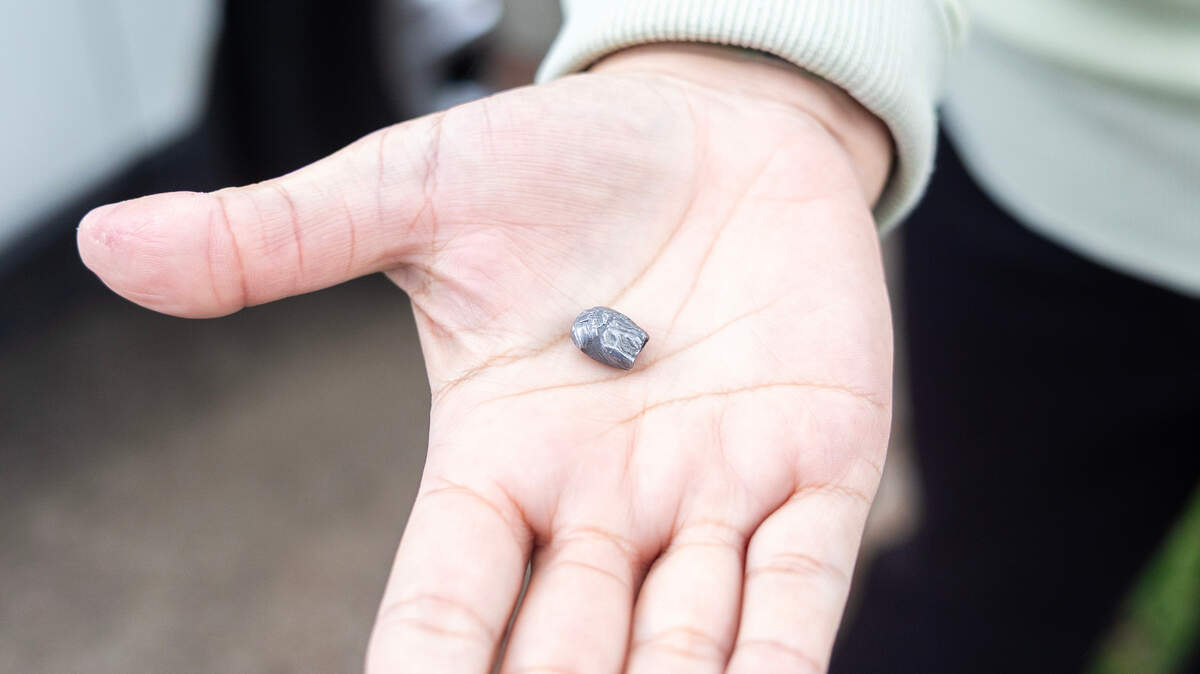 Megan Hogan shows a bullet fragment that was found in her vehicle after a group sprayed gunshots down her Waldo street in April.