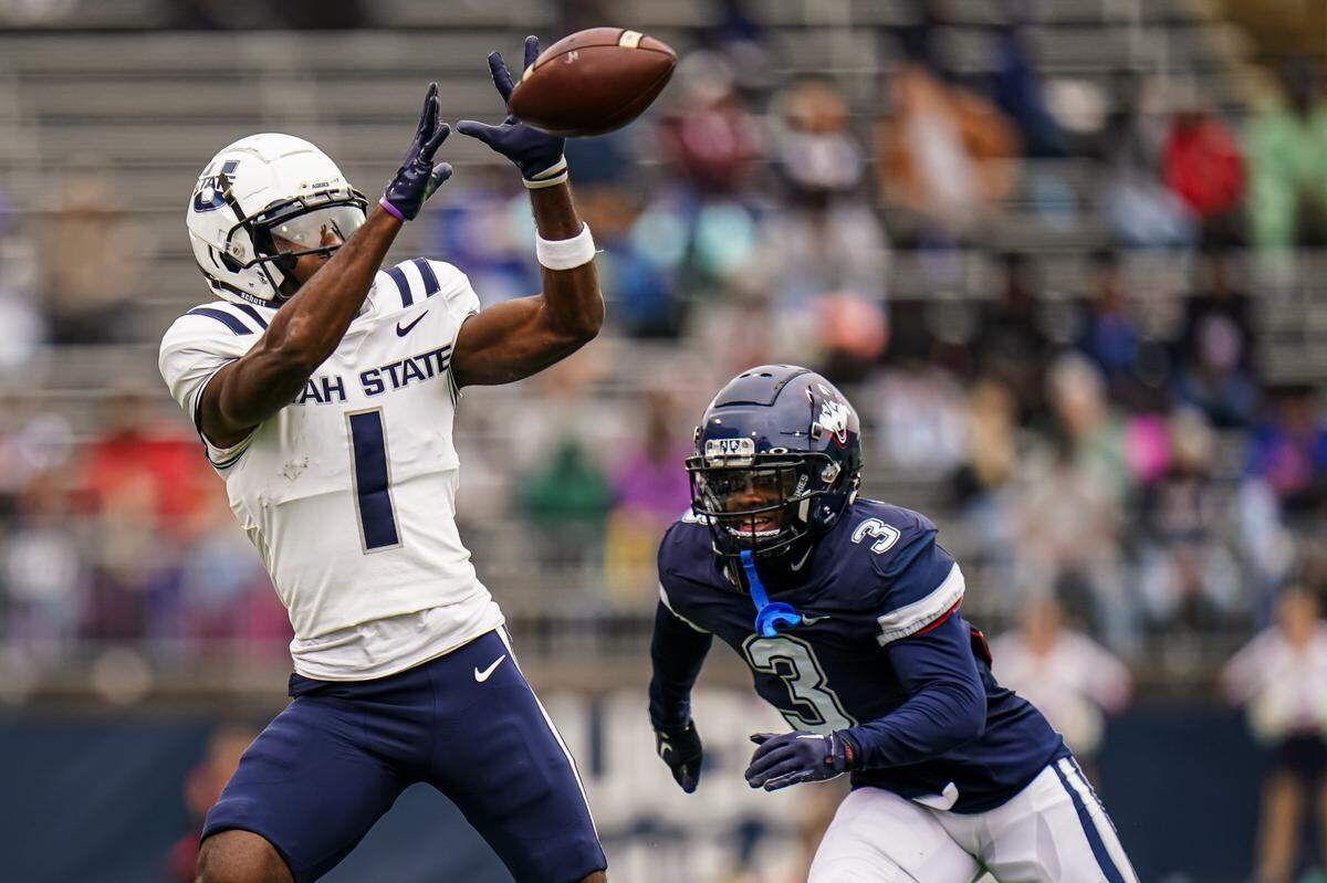 Utah State Aggies wide receiver Jalen Royals (1) makes the catch against UConn Huskies defensive back D’Mon Brinson (3) in the second quarter at Rentschler Field at Pratt & Whitney Stadium on Sept. 30, 2023.