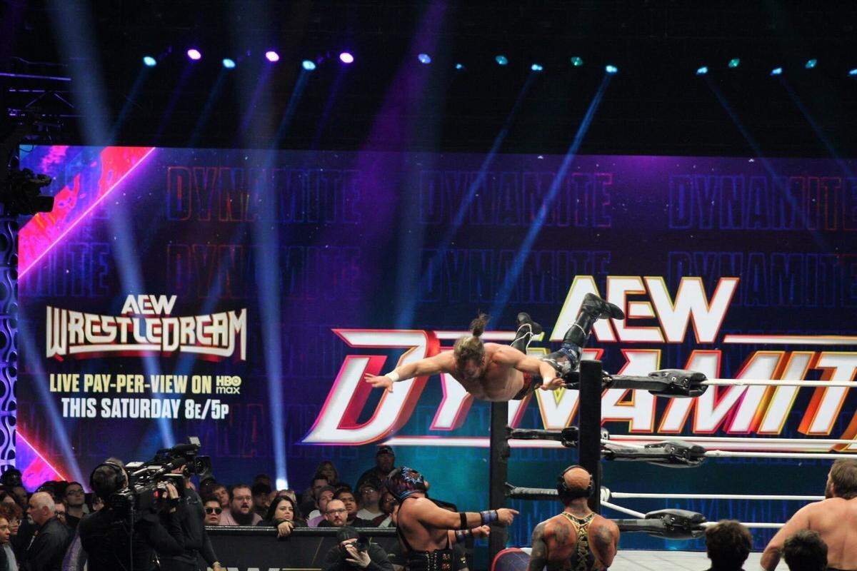 All Elite Wrestling pro wrestler Kenny Omega dives onto The Beast Mortos during their match on AEW Dynamite Wednesday, Oct. 15 at Cable Dahmer Arena in Independence.