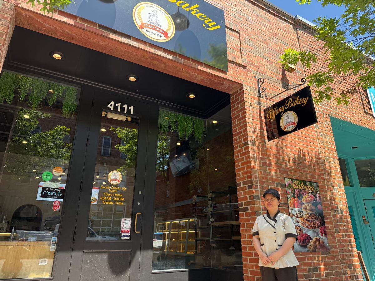 Tram “Tiffany” Dreasler stands outside her bakery in Westport.