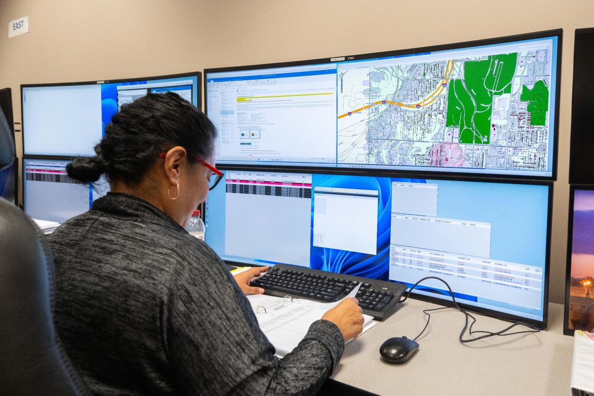 A 911 call taker reviews class notes in the Professional Development and Research Bureau of the KCPD headquarters on Thursday, April 17, 2025. This is where 911 call takers practice receiving calls to 911.