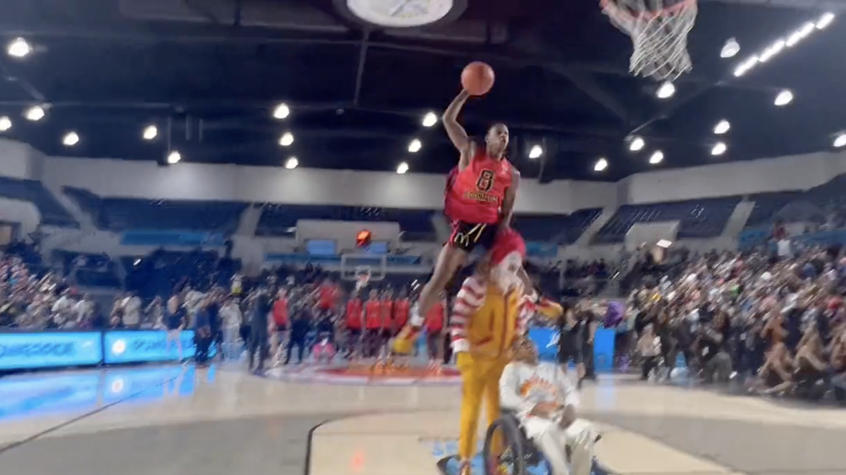 Class of 2023 Kansas recruit Elmarko Jackson throws down a dunk over Ronald McDonald during the McDonald’s All-America dunk contest.