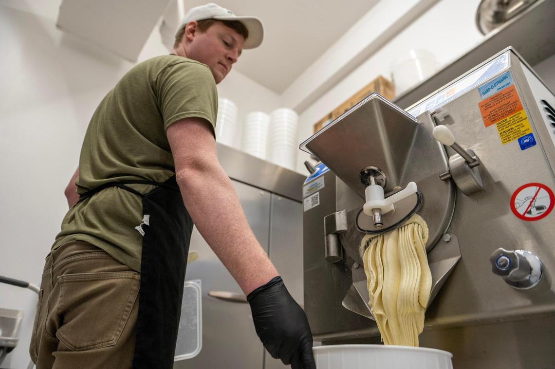 Alex Wood, owner of French Custard, prepares pistachio ice cream.