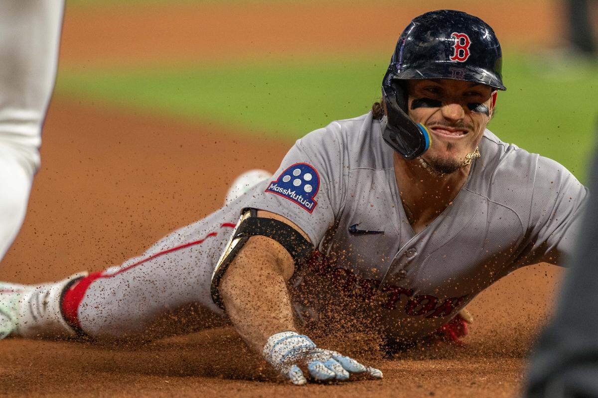 Boston Red Sox left fielder Jarren Duran slides into third base for a triple late in a game against the Boston Red Sox on Wednesday, May 20, 2026, at Kauffman Stadium.