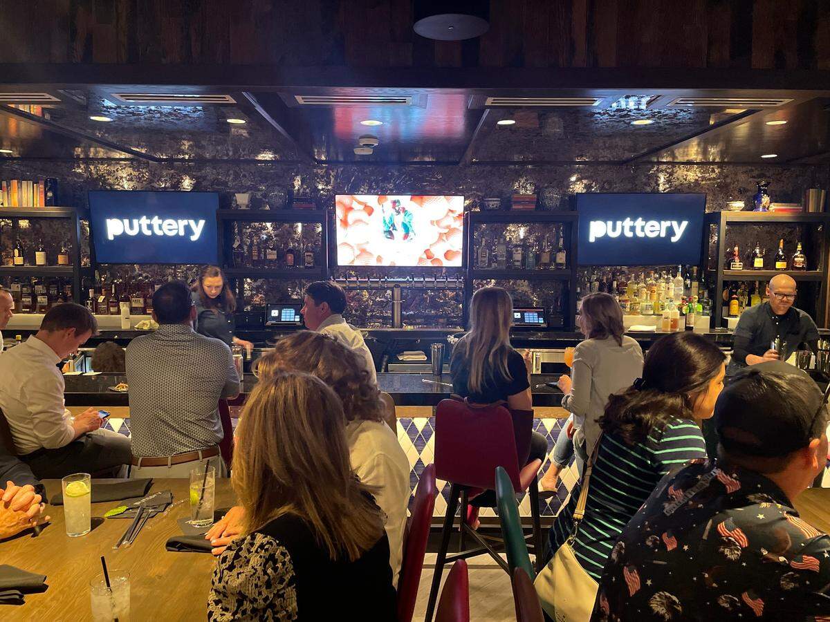 Signature drinks at Puttery include the BBQ on a Saturday Night (bourbon, honey, smoked peach, lemon, angostura bitters) and the non-alcoholic Spicy Pina Rickey (pineapple, lime, habanero, soda).