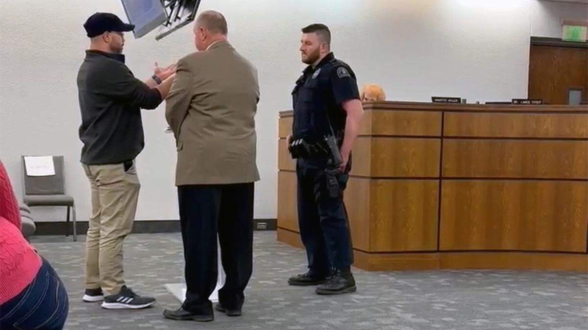 Jason Vollmecke was removed from an Independence school board meeting in January 2023, then banned from the school grounds for a year.