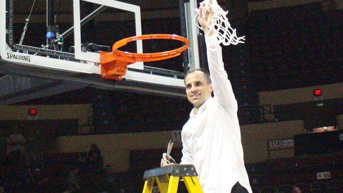 Northwest Missouri State coach Ben McCollum waves the net after the Bearcats earned their fifth straight MIAA Tournament championship.