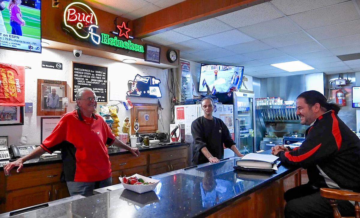 Former club president and current bar manager Kenny Yarnevich, left, and Frank Bartkoski, a past president who currently serves on the club’s board of trustees, worked the bar on a recent Monday evening and chatted with financial secretary Nick Tomasic Jr.