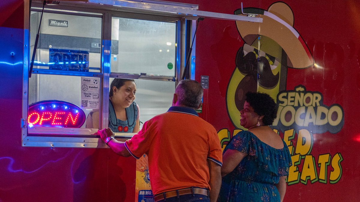 Celia Altamirano, left, takes an order from inside the Señor Avocado food truck.
