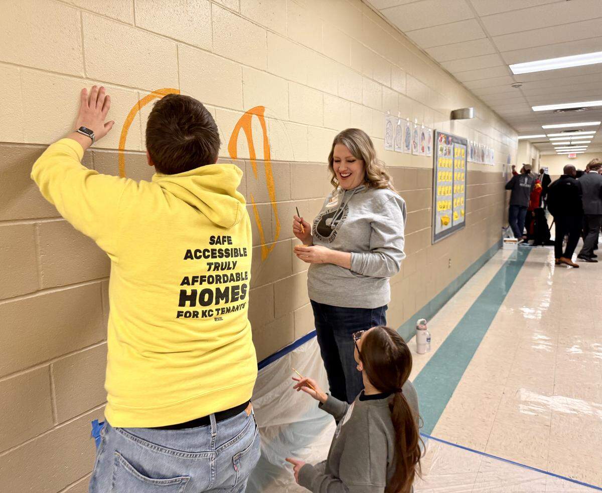 Volunteers paint murals during the Day of Service event in Kansas City.