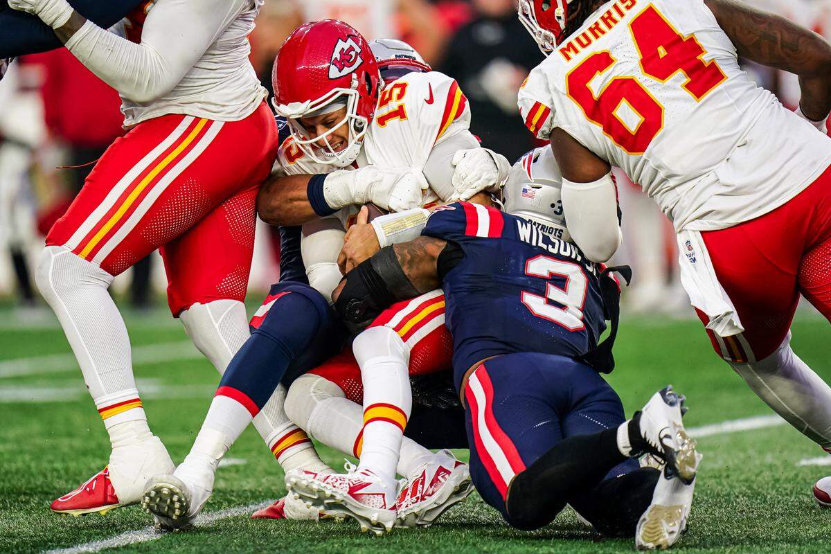 Chiefs quarterback Patrick Mahomes, at center of pile, is sacked by New England Patriots linebacker Mack Wilson Sr. during Sunday afternoon’s game at Gillette Stadium in Foxborough, Mass.