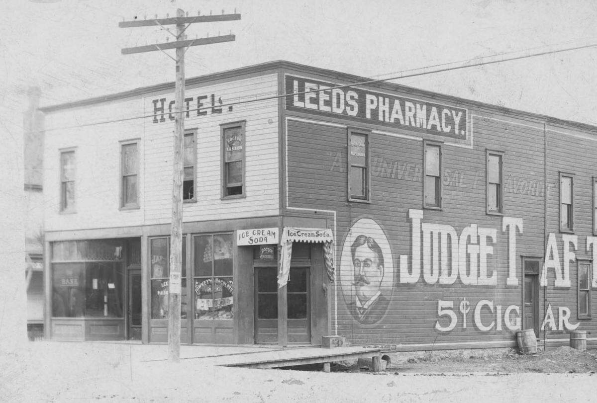 Early-1900s photograph of the Leeds Pharmacy and Hotel on E. 37th Street, across from Polfer & Renick.