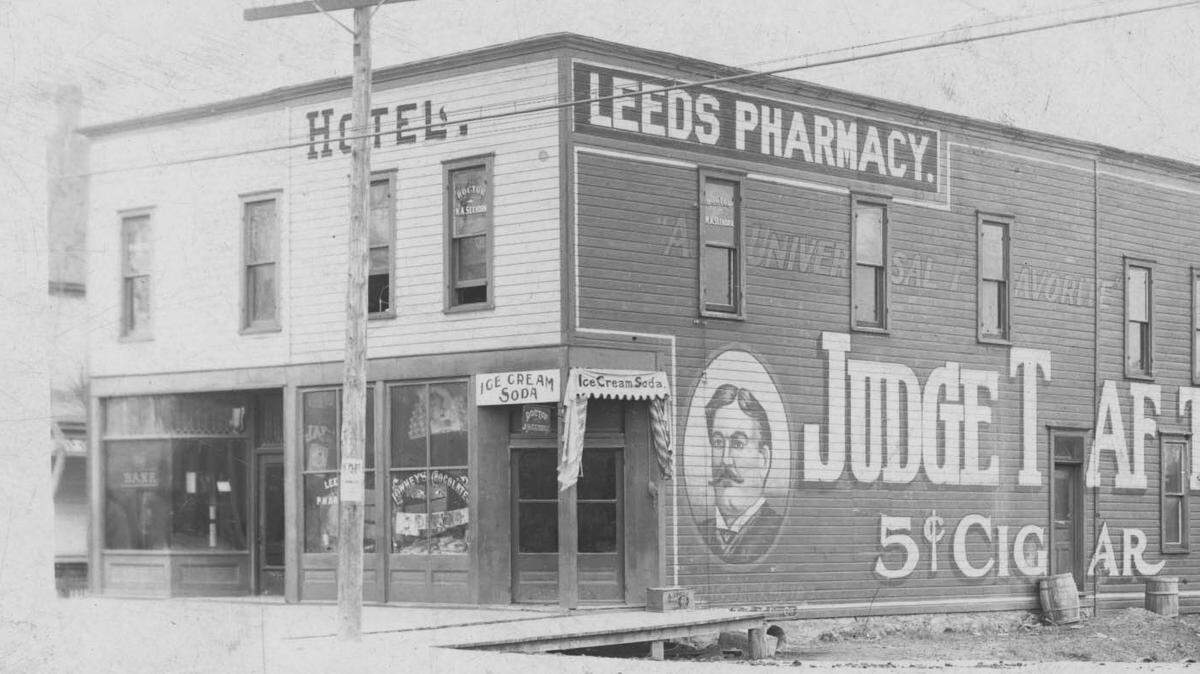 Early-1900s photograph of the Leeds Pharmacy and Hotel on E. 37th Street, across from Polfer & Renick.