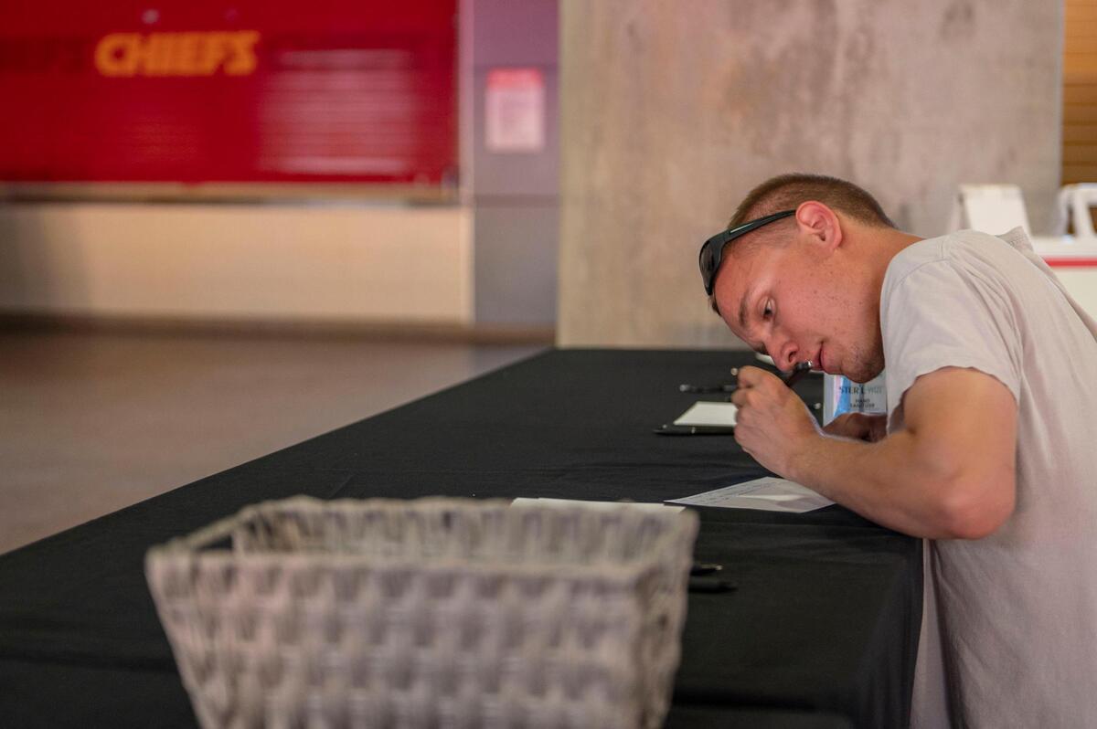 Kansas City Chiefs fan Will Sears shares a memory Len Dawson at the memorial tribute on Thursday, Sep. 1, 2022 at Arrowhead Stadium. Fans were encouraged to write a memory that they had of Dawson on a piece of paper.