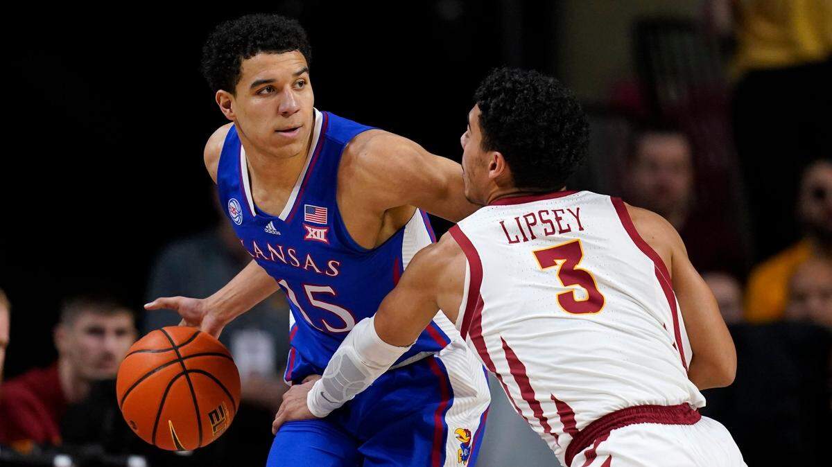 Kansas guard Kevin McCullar Jr. (15) drives around Iowa State guard Tamin Lipsey (3) during the first half of a game, Saturday, Feb. 4, 2023, in Ames, Iowa.