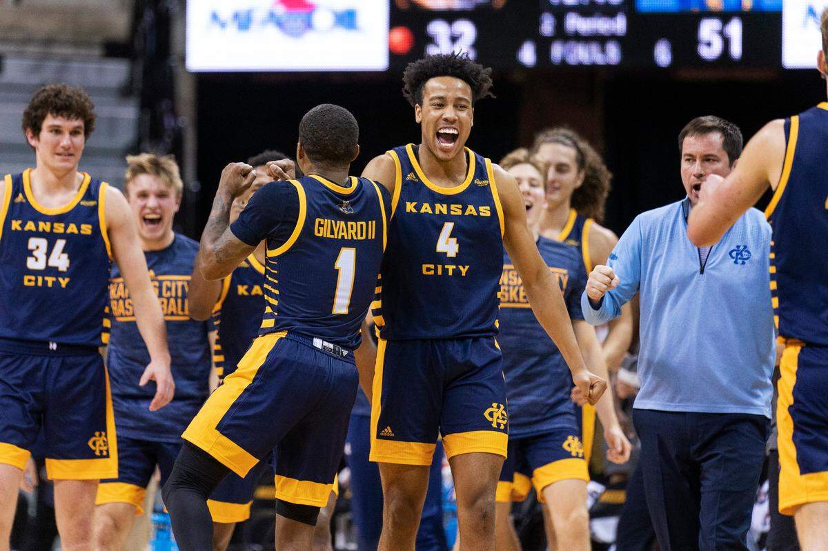 Kansas City’s Jacob Johnson (4) celebrates with teammate Evan Gilyard II (1) during a timeout in the second half of an NCAA college basketball game against Missouri Monday, Nov. 15, 2021, in Columbia, Mo. Kansas City won 80-66. (AP Photo/L.G. Patterson)