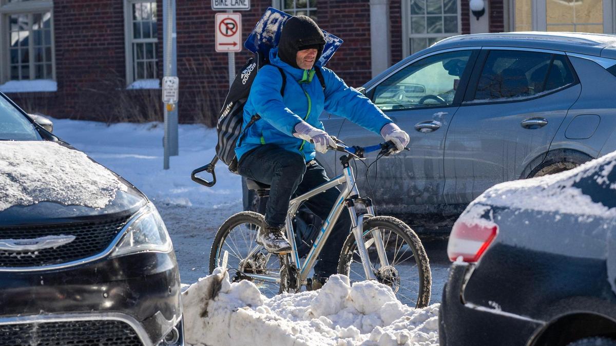 A cyclist navigates through snowmelt and slush along Armour Boulevard on Tuesday, Jan. 7, 2025, in Kansas City.