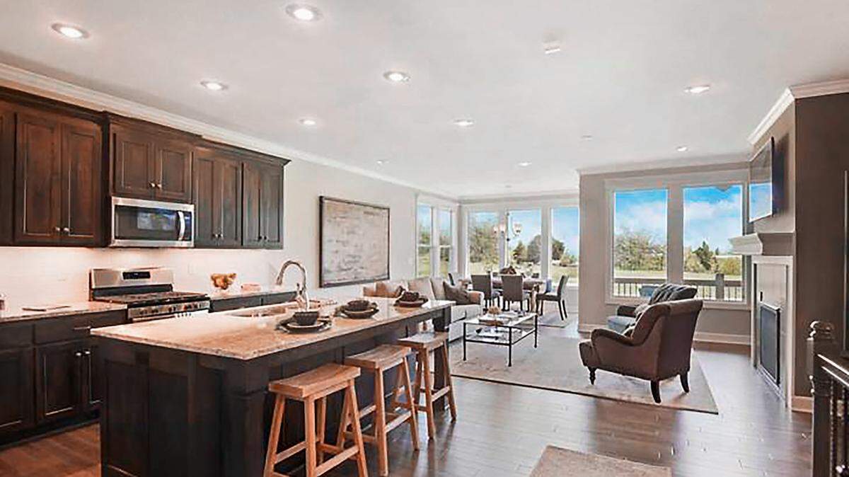 The chef-inspired kitchen includes a gas stove-top and walk-in pantry and opens to the spacious living area, providing the perfect flow for effortless entertaining. Floor to ceiling windows provide beautiful golf course views.