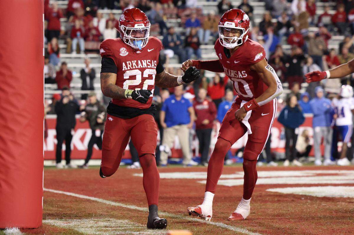 Arkansas Razorbacks running back Ja’Quinden Jackson (No. 22) celebrates with quarterback Taylen Green (No. 10) after scoring in the fourth quarter of a college football game against the Louisiana Tech Bulldogs at Donald W. Reynolds Razorback Stadium in Fayetteville, Ark., on Saturday, Nov. 23, 2024.