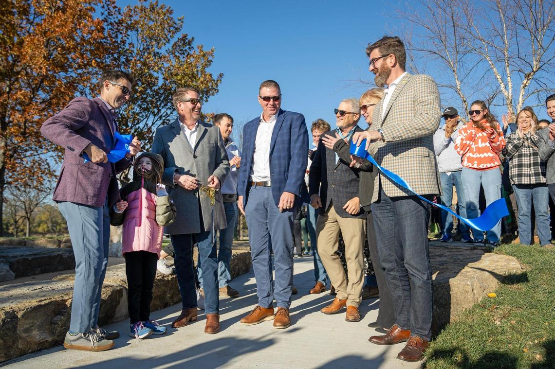 Councilman Eric Bunch, from left, Gordon Lansford, CEO, JE Dunn Construction, Jeff Blaesing senior VP JE Dunn Construction, and Jon Stephens, Port KC President and CEO, far right, and others react after cutting the ribbon on Riverfront Boulder @ Berkley, a new urban bouldering park on Wednesday at the Berkley Riverfront in Kansas City.