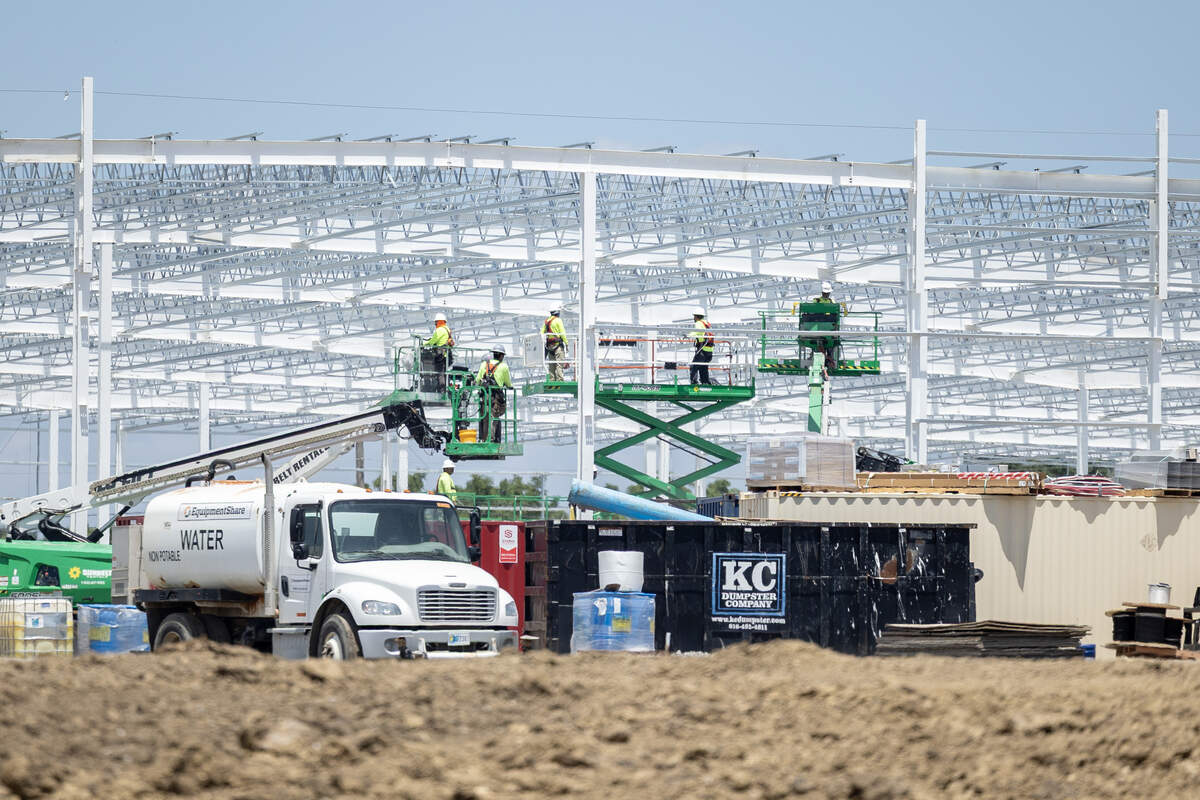 Work crews work at the site of Lee’s Summit’s new Costco store near the Missouri 291-U.S. 50 interchange on Tuesday, July 7.