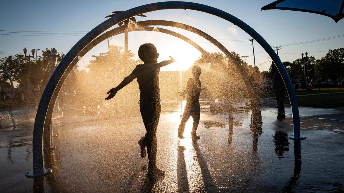 Muhammed Sharif, 6, runs with Yasin Vahir, 6, not far behind through the water features at Dagg Park in Kansas City on Wednesday, July 20, 2022. Temperatures are expected to reach record breaking levels over the upcoming weekend.