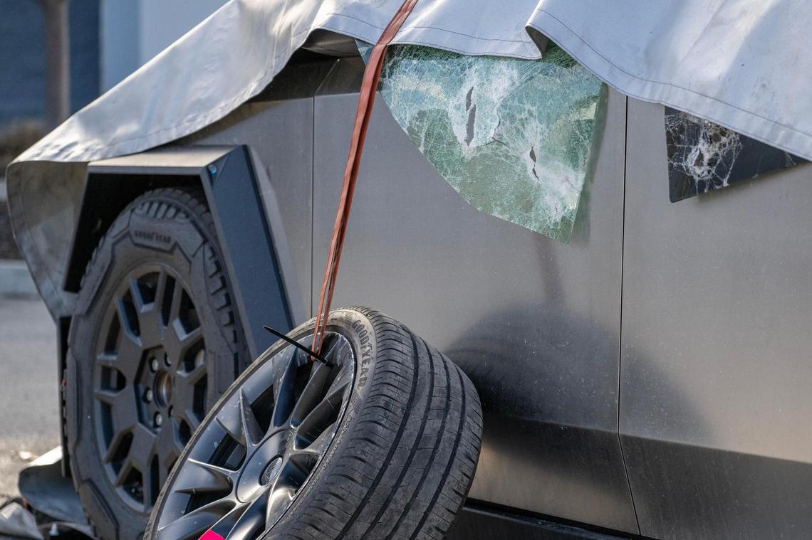 Broken glass from a burned Tesla Cybertruck is seen at a Tesla dealership on March 18 in Kansas City. The suspect is believed to have used a Molotov cocktail to set the vehicle alight.