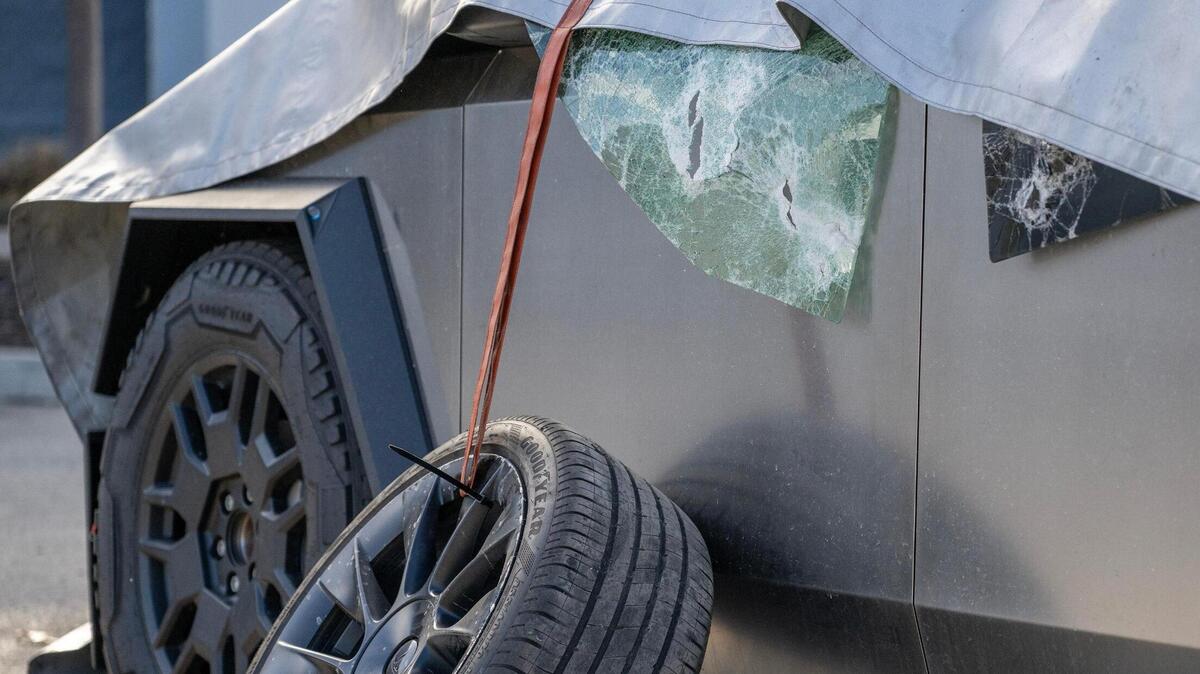 Broken glass from a burned Tesla Cybertruck is seen at a Tesla dealership on Tuesday, March 18, 2025, in Kansas City. Fire crews responded to the dealership at 10111 State Line Road late Monday night to extinguish the blaze. The cause of the fire was investigated by bomb and arson authorities.
