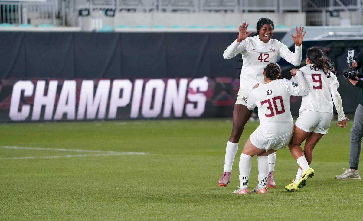 Forward Wrianna Hudson #42 celebrates with midfielder Marianyela Jimenez #30 and forward Taylor Suarez #9 of the Florida State Seminoles after winning the NCAA Division I Women's Soccer Championship over the Stanford Cardinal at CPKC Stadium on December 8, 2025 in Kansas City.