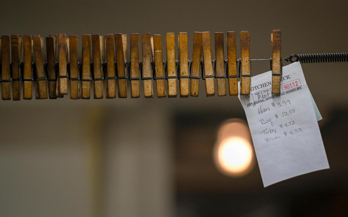 Customers’ orders are clipped to clothespins hanging on a line in the&nbsp;kitchen.