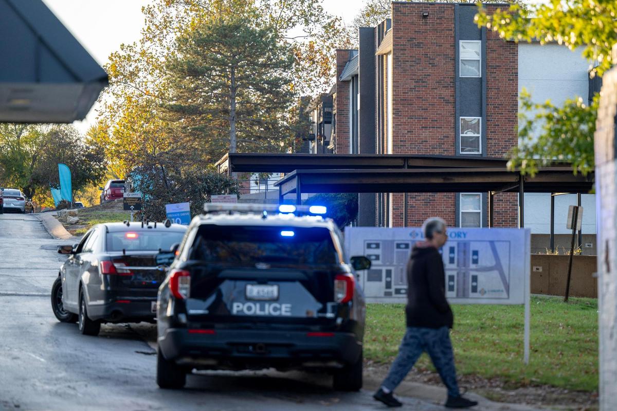 Police cars line East Larkspur Lane during an officer-involved shooting at the Oval Spring Apartments on Thursday, Nov. 7, 2024, in Independence.