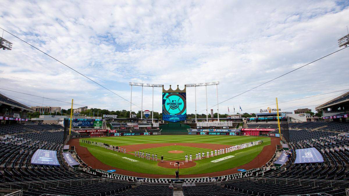 The Kansas City Royals and Chicago White Sox lined the field at an empty Kauffman Stadium for the national anthem before the 2020 home opener on July 31.